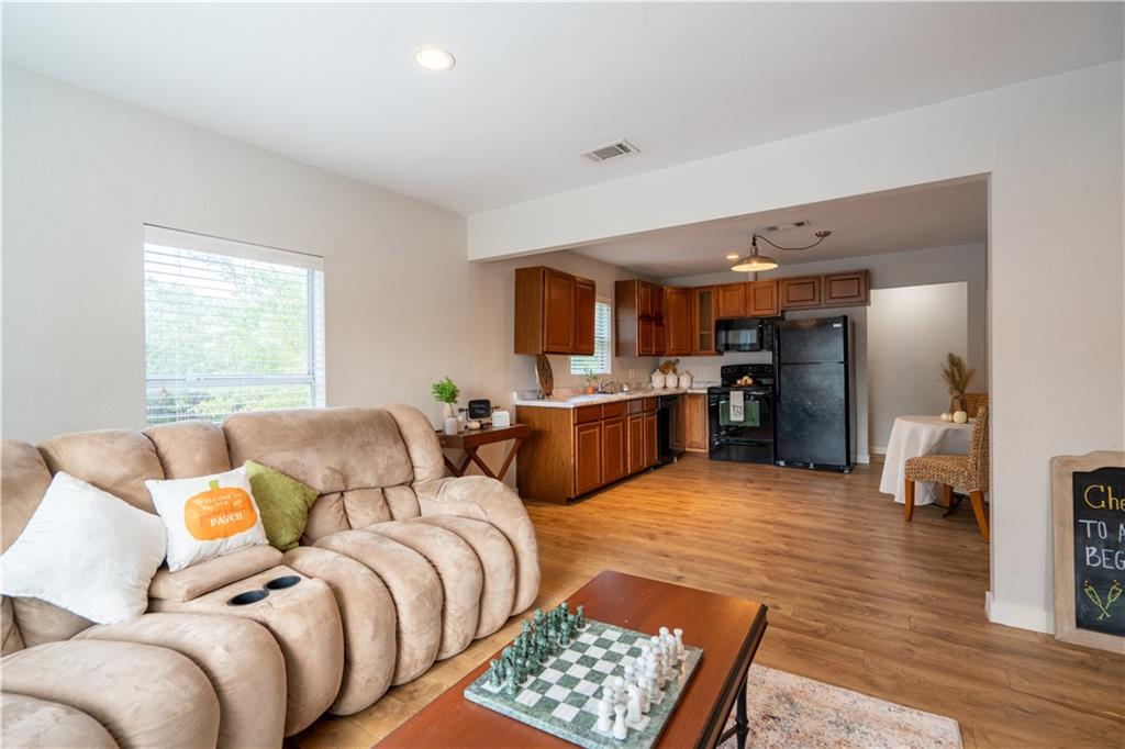 301 North Lewis Street Round Rock, TX 78664 - Photo 6 of 12 a bedroom with furniture and a wooden floor