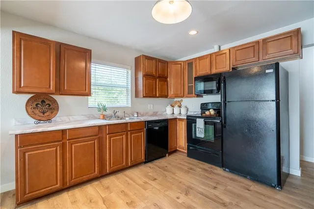 a kitchen with a refrigerator and a wooden floors