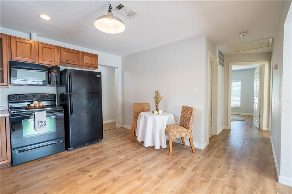 301 North Lewis Street Round Rock, TX 78664 - Photo 10 of 12 a kitchen with a refrigerator and a wooden floors
