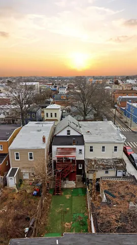 an aerial view of residential houses with outdoor space and parking