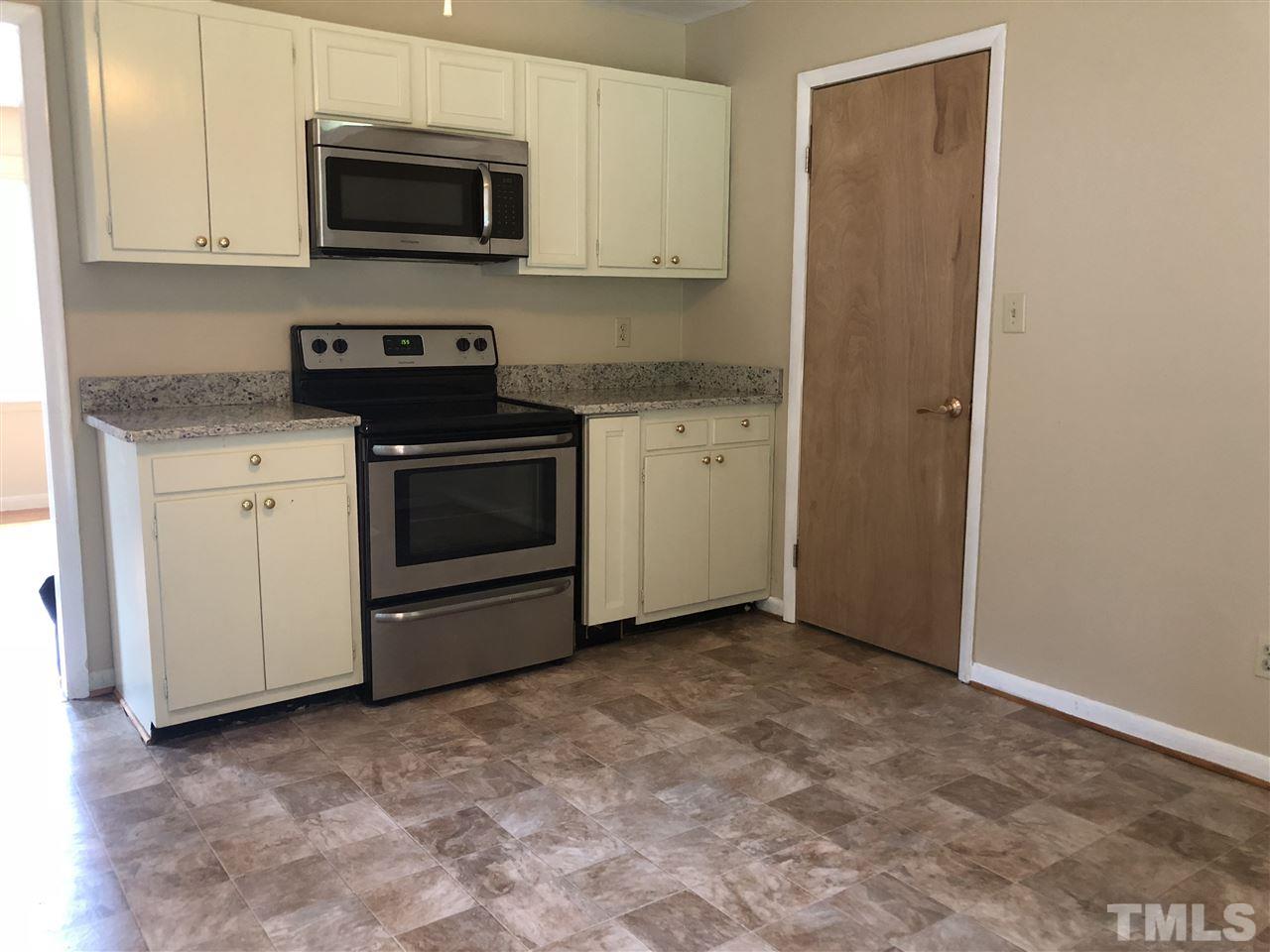 822 Chatham Lane Raleigh, NC 27610 - Photo 5 of 13 a kitchen with a stove and a microwave