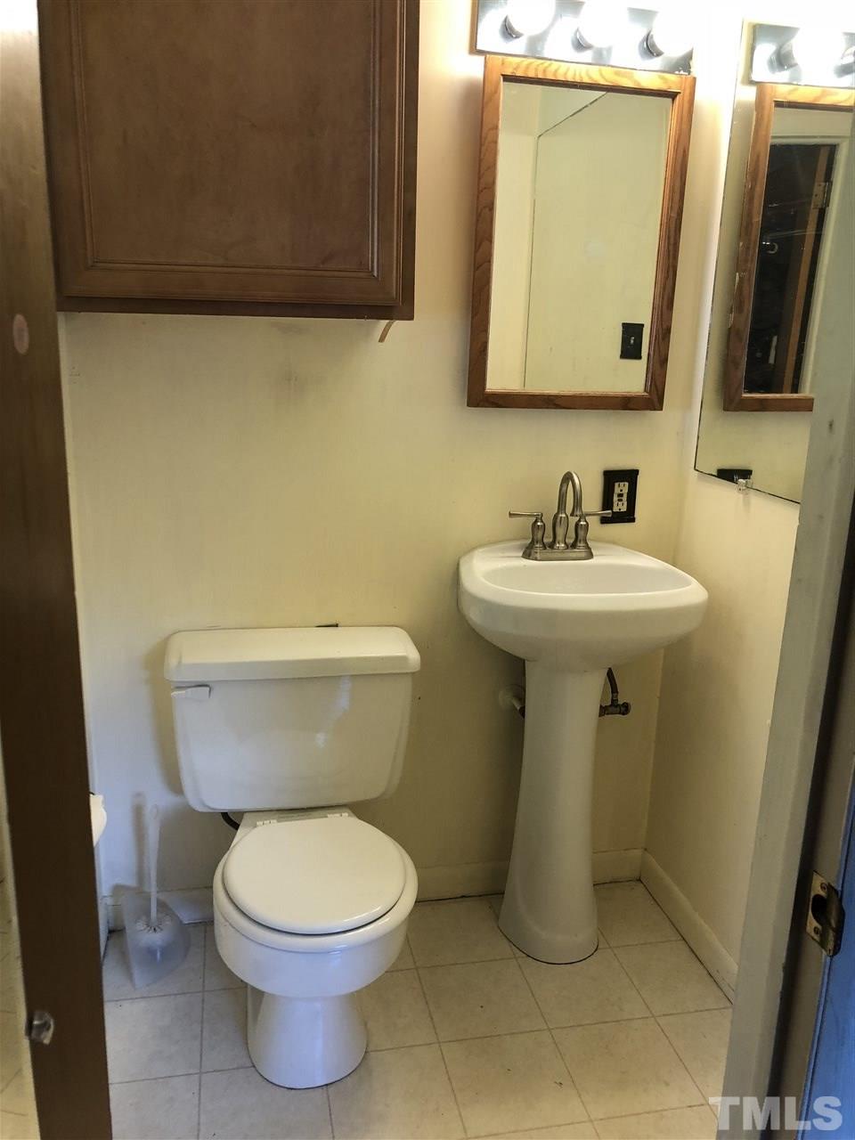 822 Chatham Lane Raleigh, NC 27610 - Photo 10 of 13 a bathroom with a toilet sink and mirror