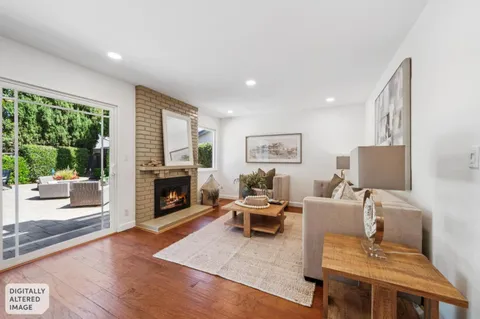 a bathroom with a granite countertop sink a toilet and a mirror