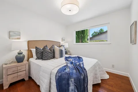 a bedroom with a bed and a chair
