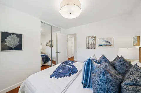 a bedroom with a bed and large window