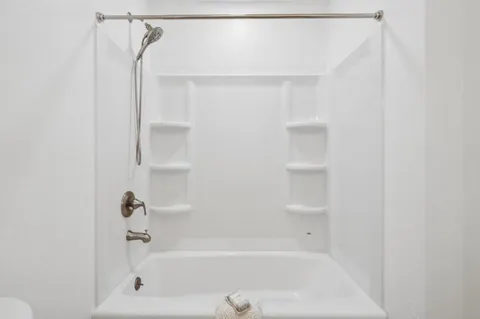 a view of a patio with table and chairs potted plants and large tree