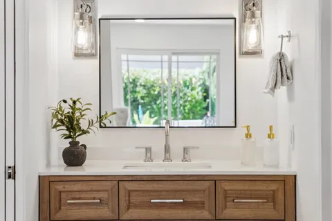 a view of a wooden house with a fountain and a fountain