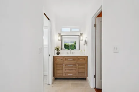 a view of a patio with a table and chairs and a barbeque