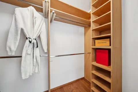 a view of a backyard with potted plants and wooden fence