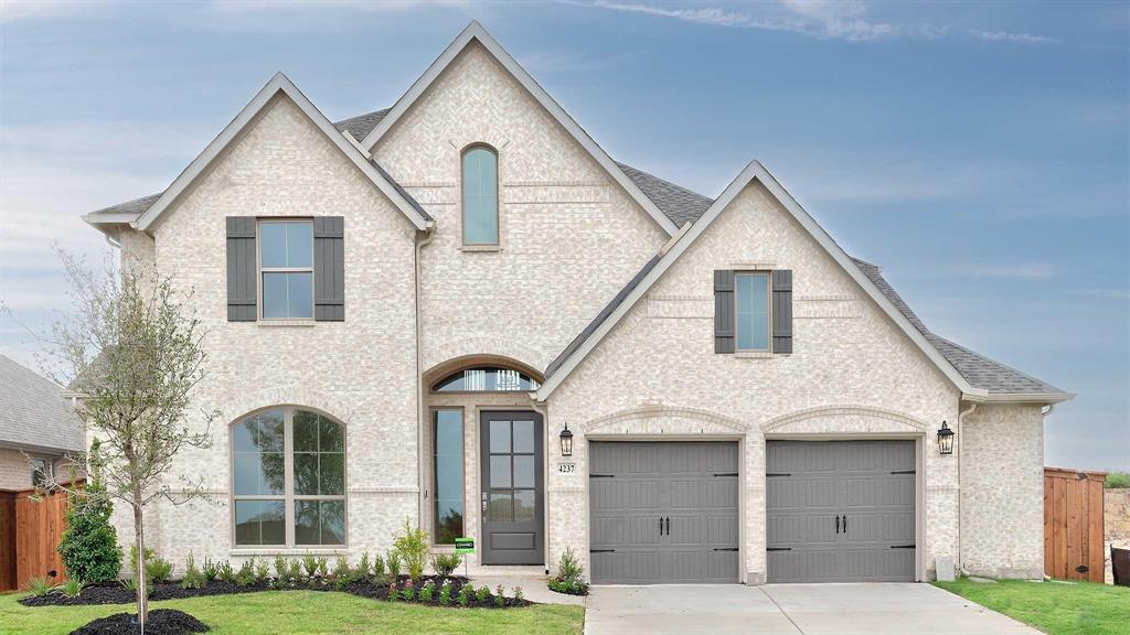 4237 Capstone Road Midlothian, TX 76065 - Photo 1 of 25 Brick exterior with dark gray shutters, an arched entry, a two-car garage, and established landscaping