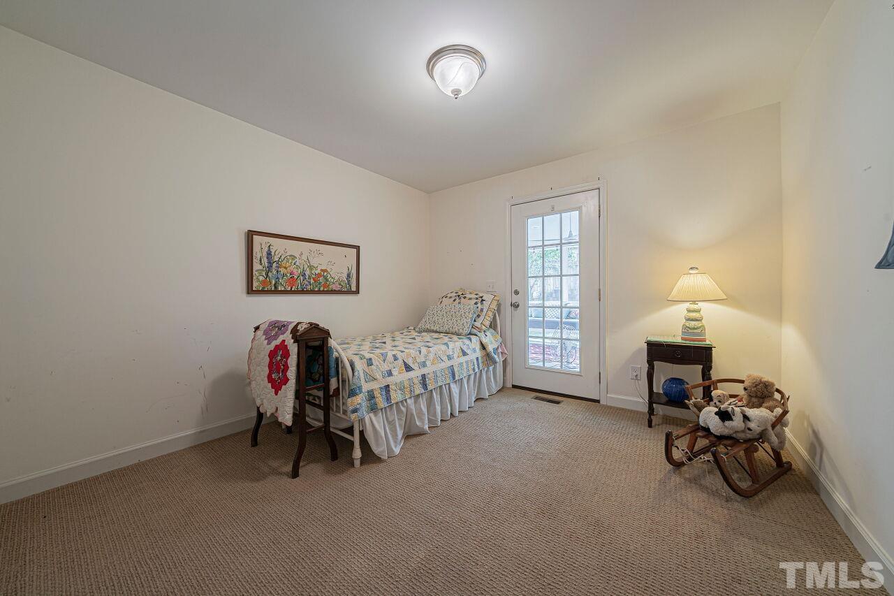 2617 Grant Avenue Raleigh, NC 27608 - Photo 16 of 28 a bed room with a bed and a chair