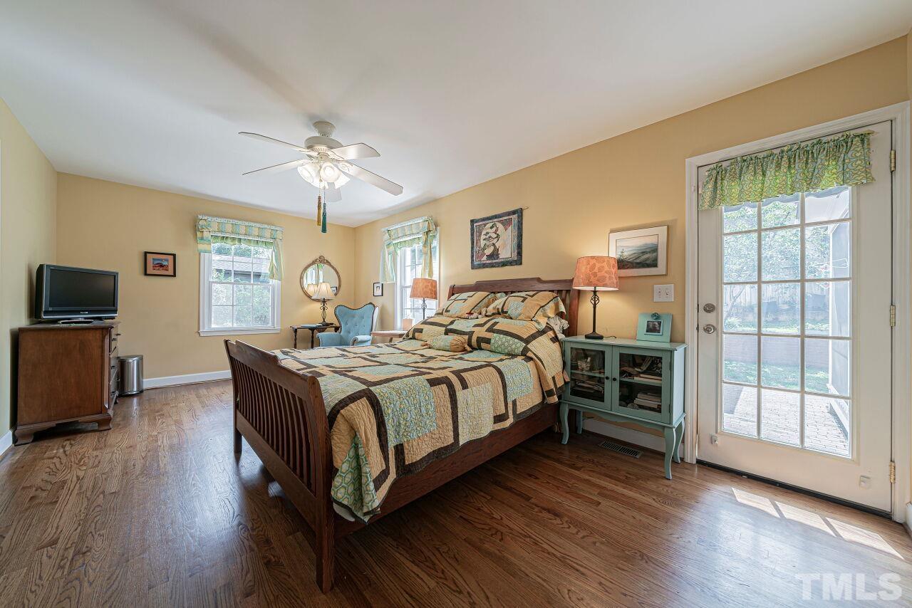 2617 Grant Avenue Raleigh, NC 27608 - Photo 17 of 28 a bedroom with a bed and a tv on table