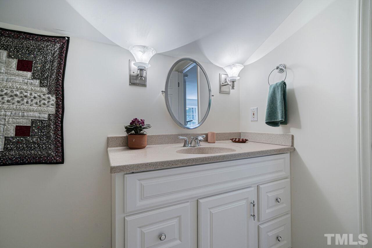 2617 Grant Avenue Raleigh, NC 27608 - Photo 24 of 28 a bathroom with a double vanity sink and a mirror