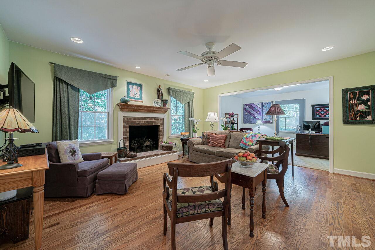 2617 Grant Avenue Raleigh, NC 27608 - Photo 6 of 28 a living room with furniture a fireplace and a flat screen tv