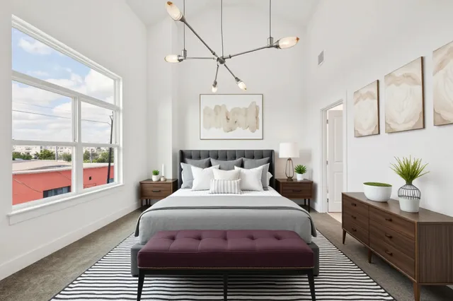 a bedroom with a large bed and a window