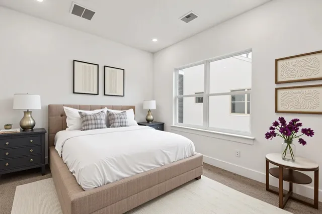 a bedroom with a bed and a potted plant