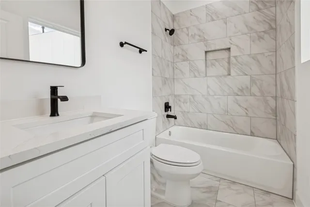 a bathroom with a sink a toilet and a bathtub