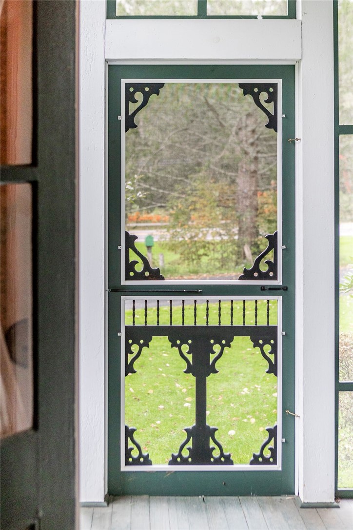 67 Fisk Road Bovina, NY 13753 - Photo 23 of 48 Ornate custom woodwork graces this charming screen door opening to peaceful lawn views.