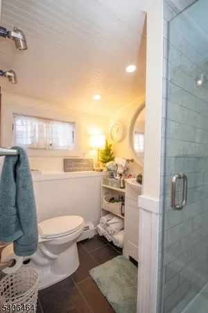 a bathroom with a toilet and a shower