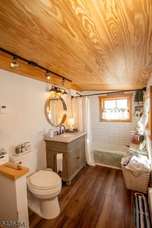 a bathroom with a sink a toilet and a window