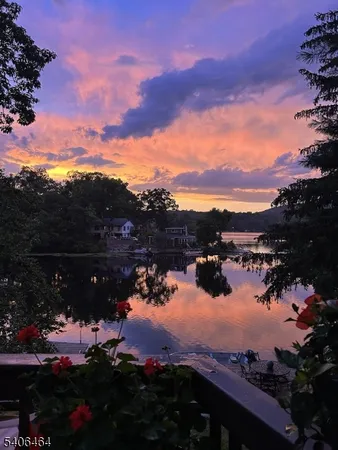 a view of a lake in middle of the sunset