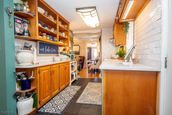 a kitchen with stainless steel appliances granite countertop a sink dishwasher stove and cabinets