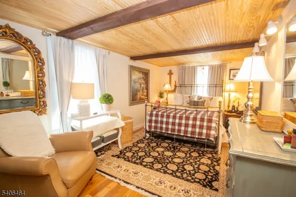 a bedroom with furniture and a large window