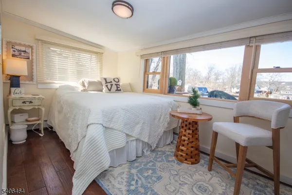 a bed room with a bed and a chair