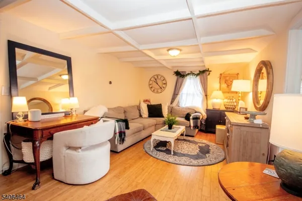 a living room with furniture a rug and white walls