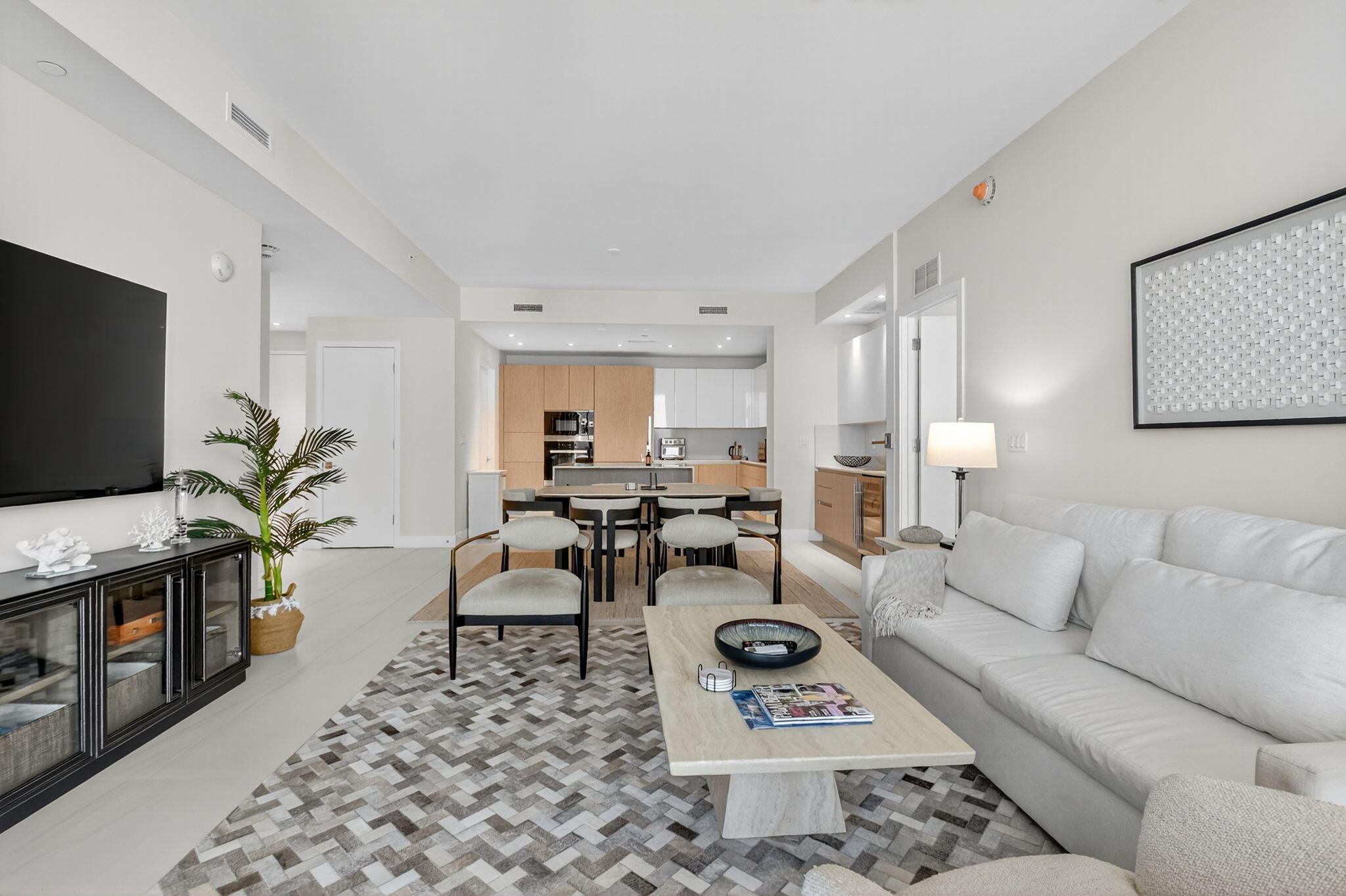 3100 North Ocean Drive, Unit 1210H Singer Island, FL 33404 - Photo 12 of 93 a living room with furniture a flat screen tv and a rug