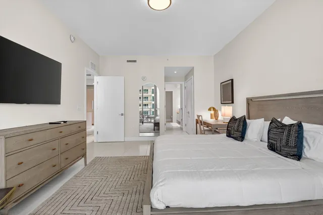 a bathroom with a toilet sink vanity and shower