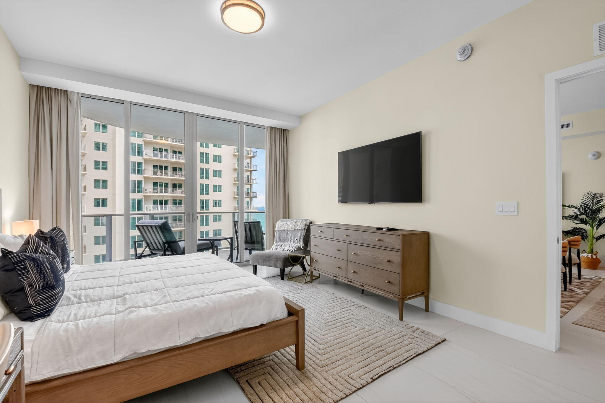 3100 North Ocean Drive, Unit 1210H Singer Island, FL 33404 - Photo 25 of 93 a bedroom with a bed and flat screen tv