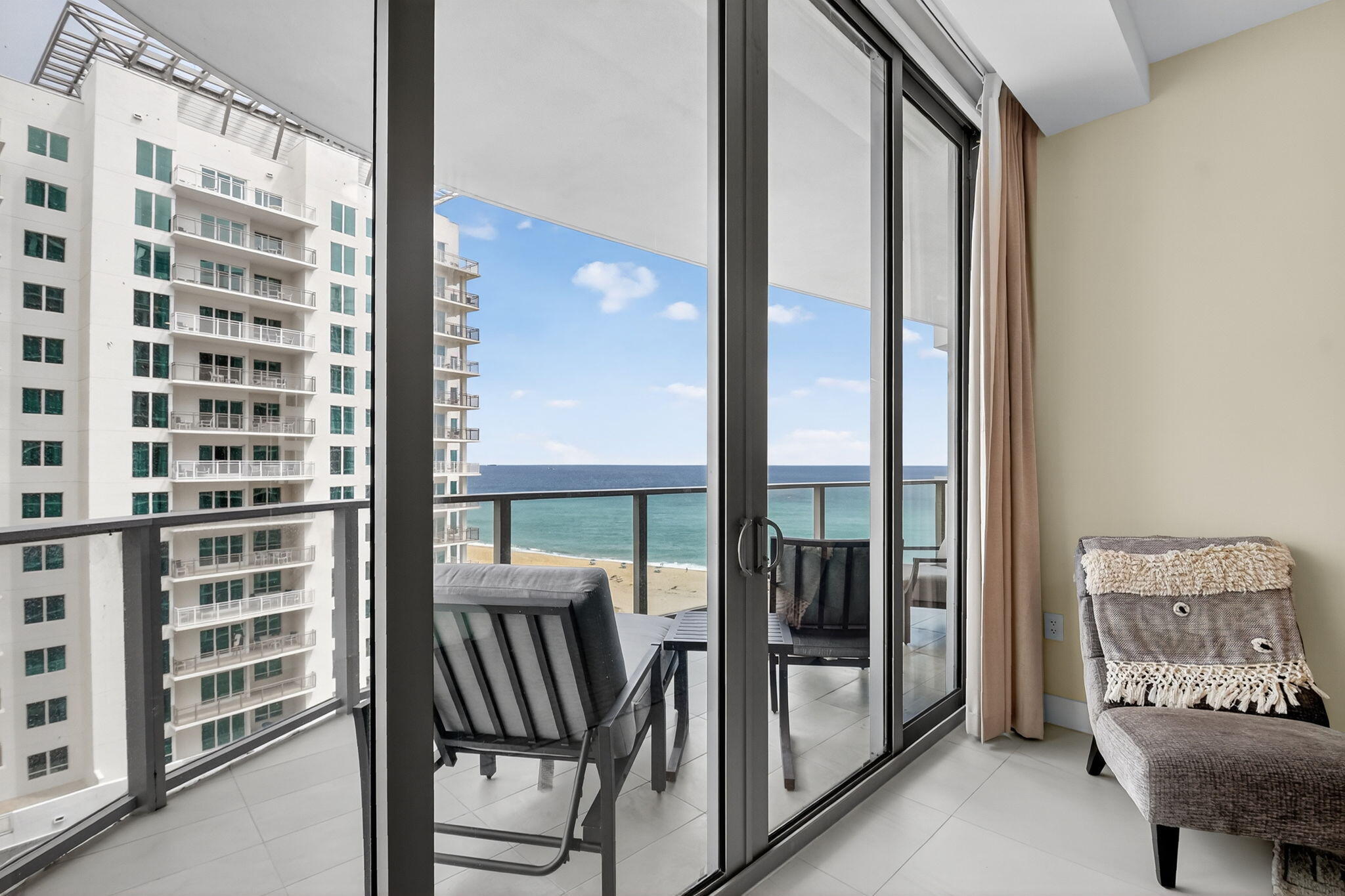 3100 North Ocean Drive, Unit 1210H Singer Island, FL 33404 - Photo 26 of 93 a view of a balcony with chair and floor to ceiling window