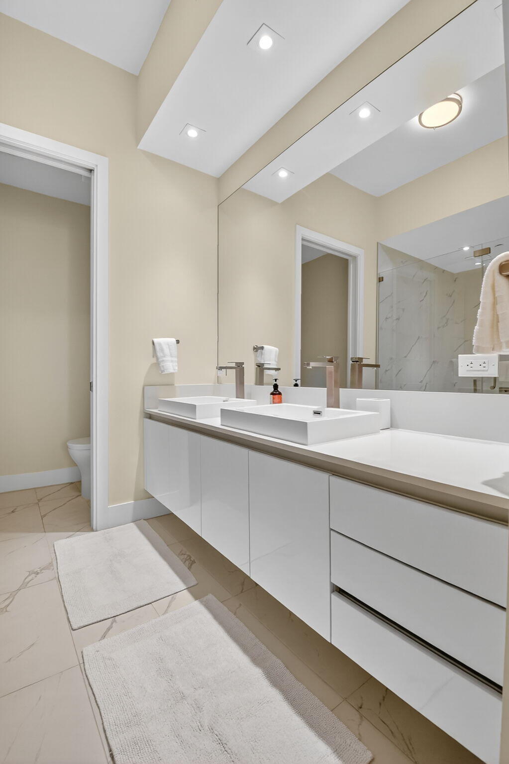 3100 North Ocean Drive, Unit 1210H Singer Island, FL 33404 - Photo 30 of 93 a bathroom with a double vanity sink and a mirror