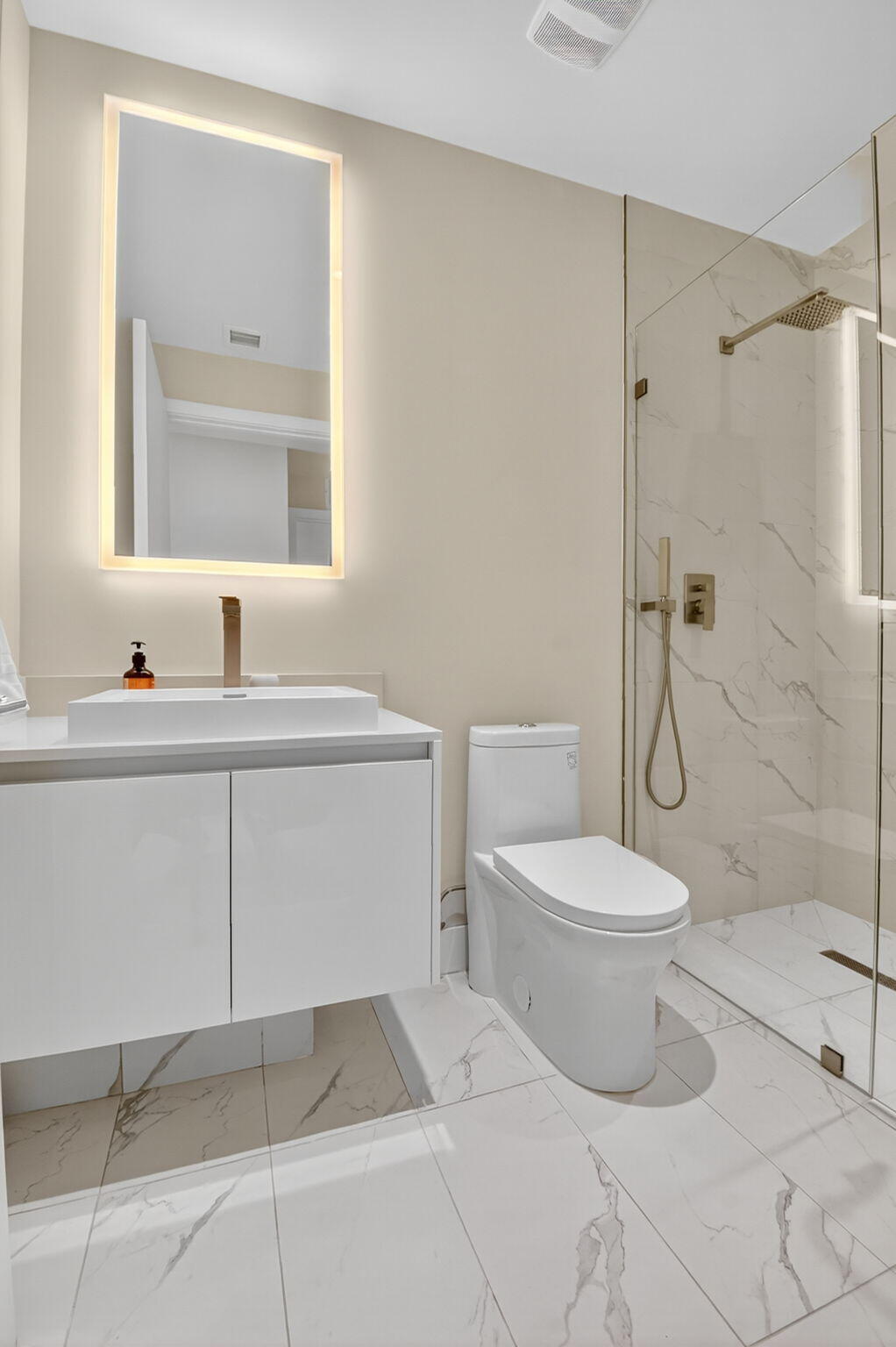 3100 North Ocean Drive, Unit 1210H Singer Island, FL 33404 - Photo 38 of 93 a bathroom with a toilet sink vanity and shower