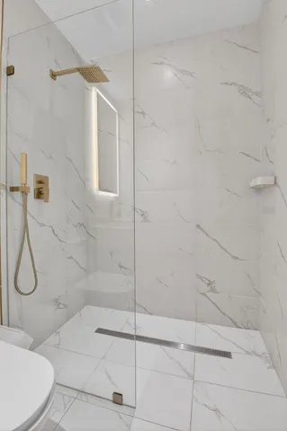 a living room with furniture and a kitchen