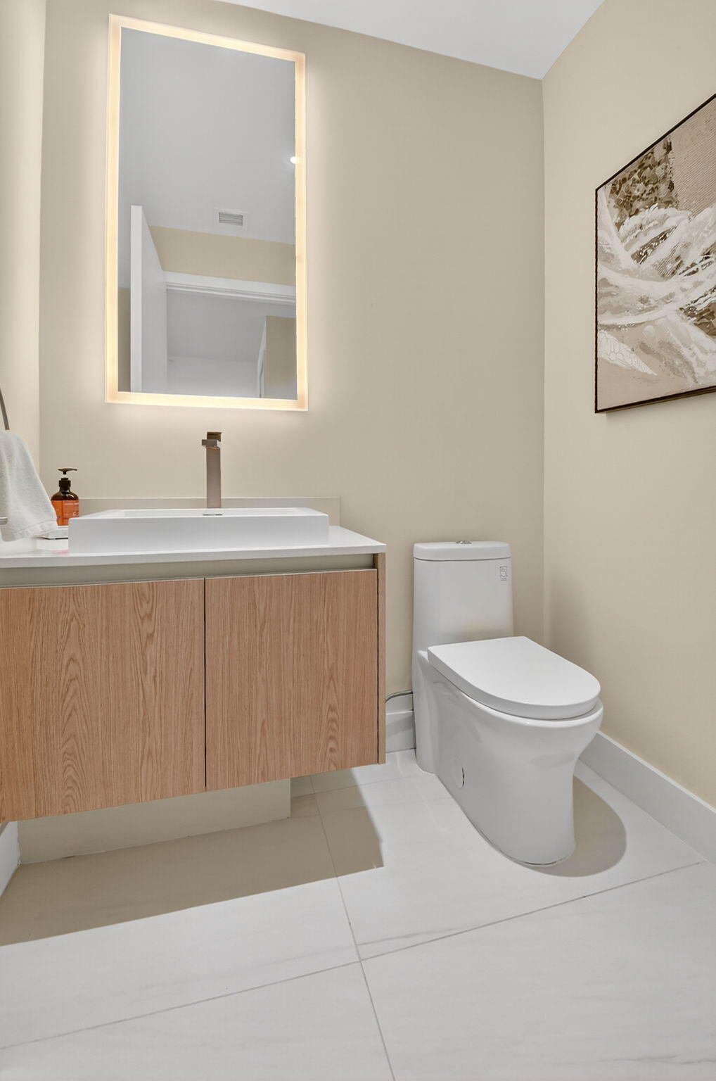 3100 North Ocean Drive, Unit 1210H Singer Island, FL 33404 - Photo 42 of 93 a bathroom with a toilet a sink and mirror