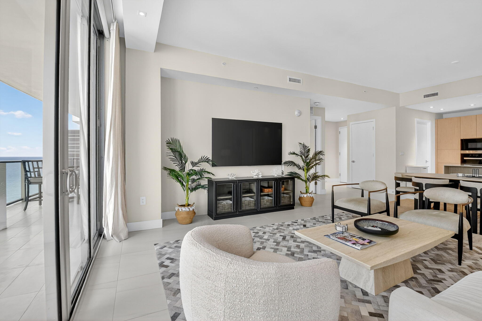 3100 North Ocean Drive, Unit 1210H Singer Island, FL 33404 - Photo 5 of 93 a living room with furniture a flat screen tv and a table