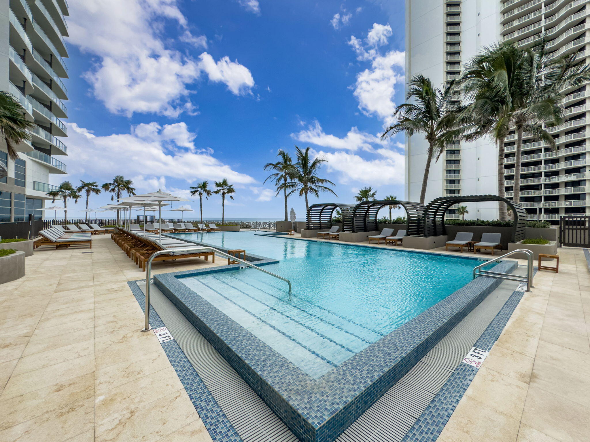 3100 North Ocean Drive, Unit 1210H Singer Island, FL 33404 - Photo 63 of 93 a view of a swimming pool with a lounge chairs