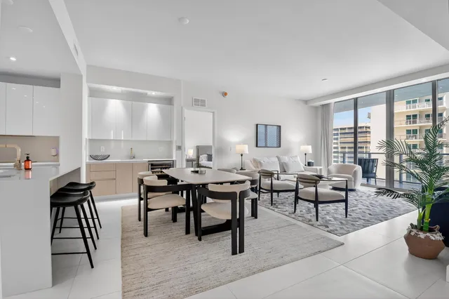 a living room with furniture a lamp and a large window