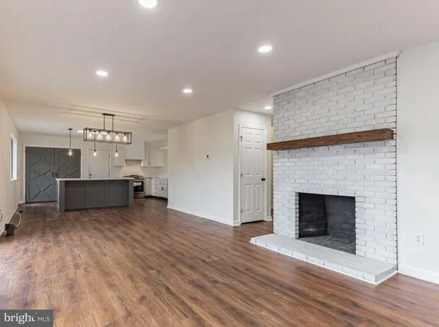 a view of a kitchen with a sink and a fireplace