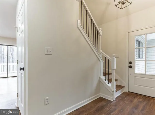 a view of entryway with stairs and wooden floor