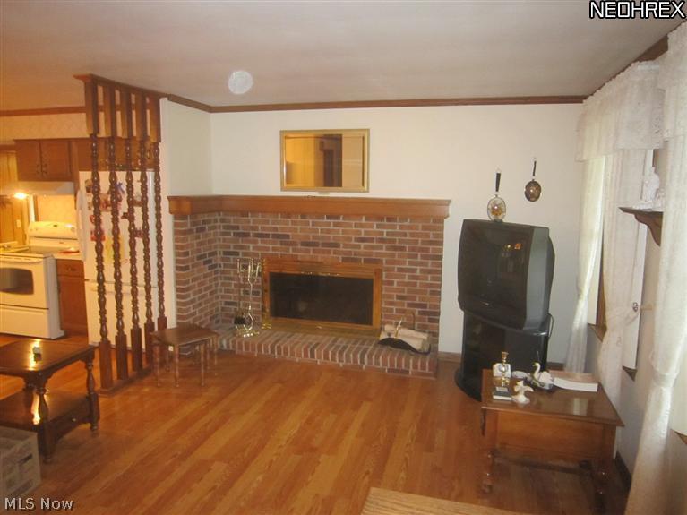 6220 South Raccoon Road Canfield, OH 44406 - Photo 7 of 13 View of the living room area showing the kitchen area to the left. The wood burning fireplace has been converted to gas logs.