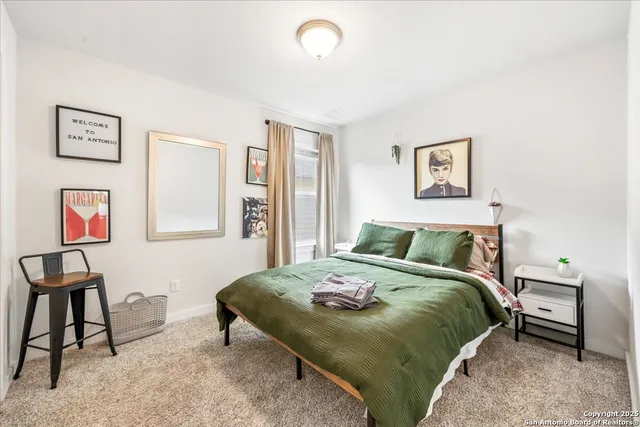 a bedroom with a bed and a painting on the wall