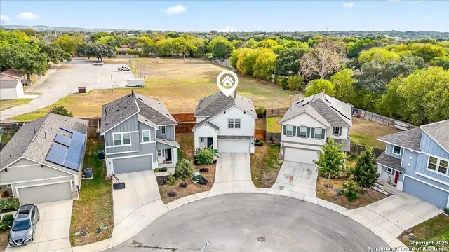 an aerial view of a house with a ocean view