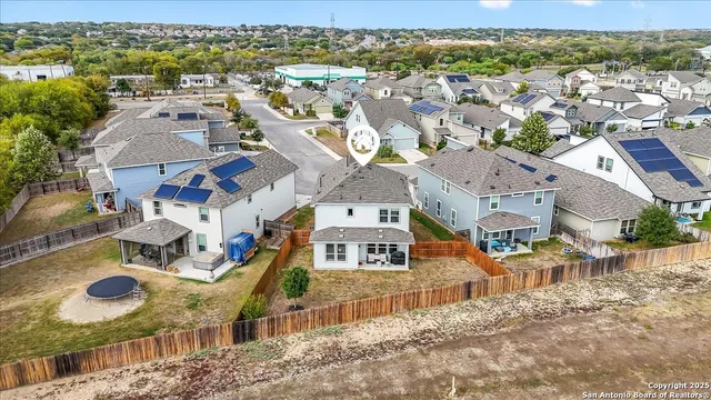 an aerial view of residential houses with outdoor space