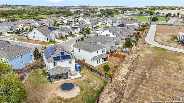an aerial view of residential houses with outdoor space