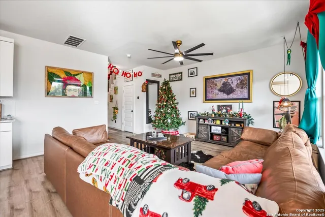 a living room with furniture a rug and white walls