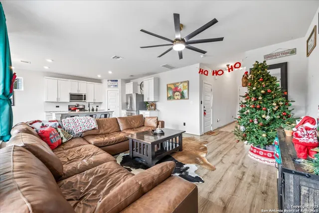 a living room with furniture and flowers
