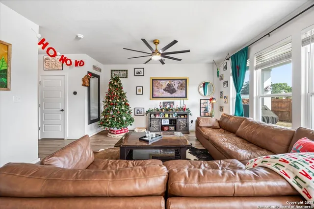 a living room with furniture flowerpot and a large window